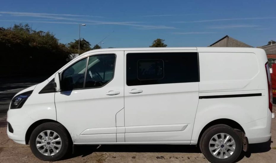 White Ford Transit Custom Crew van from side view